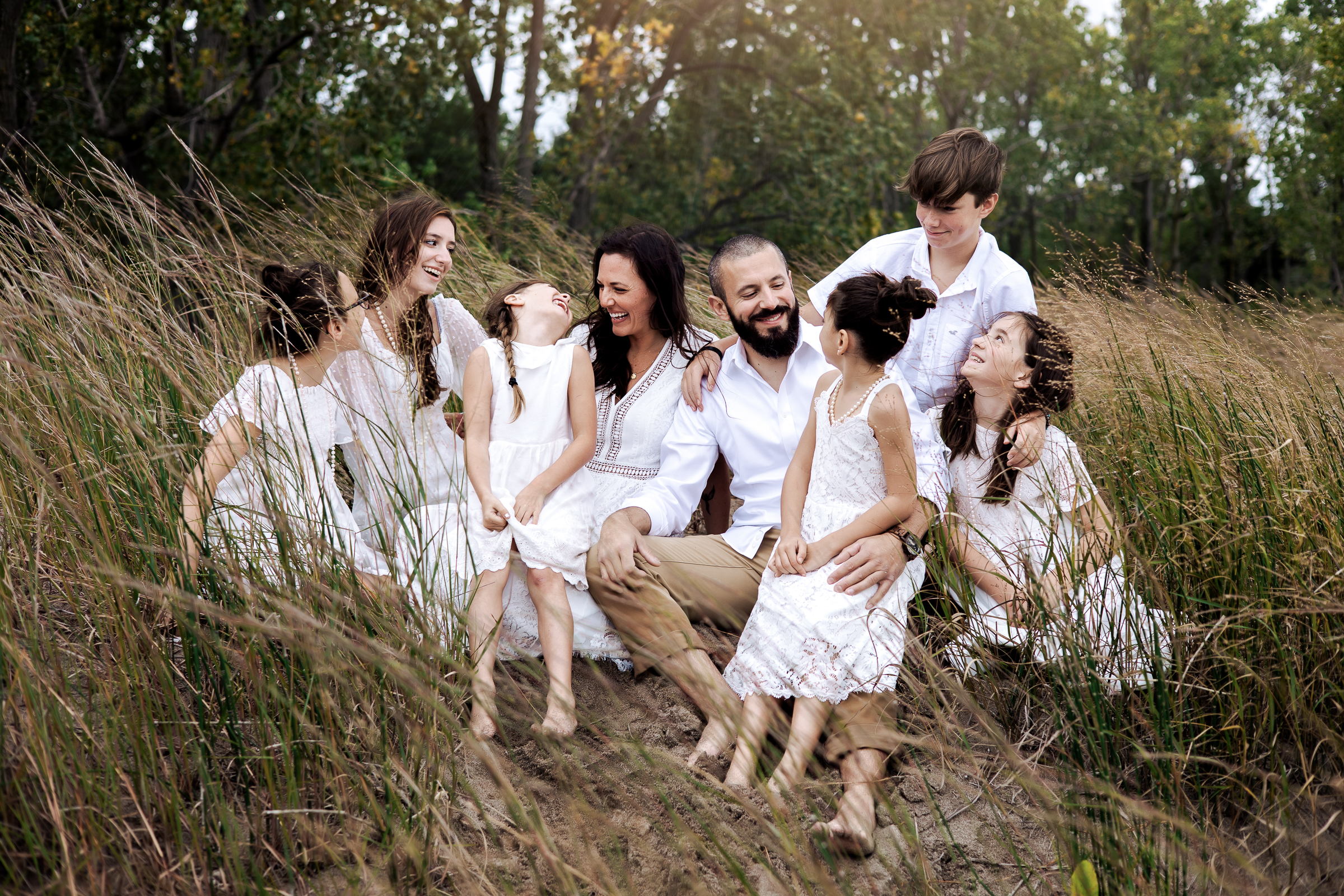 family laughing together on a beach in Erie, PA